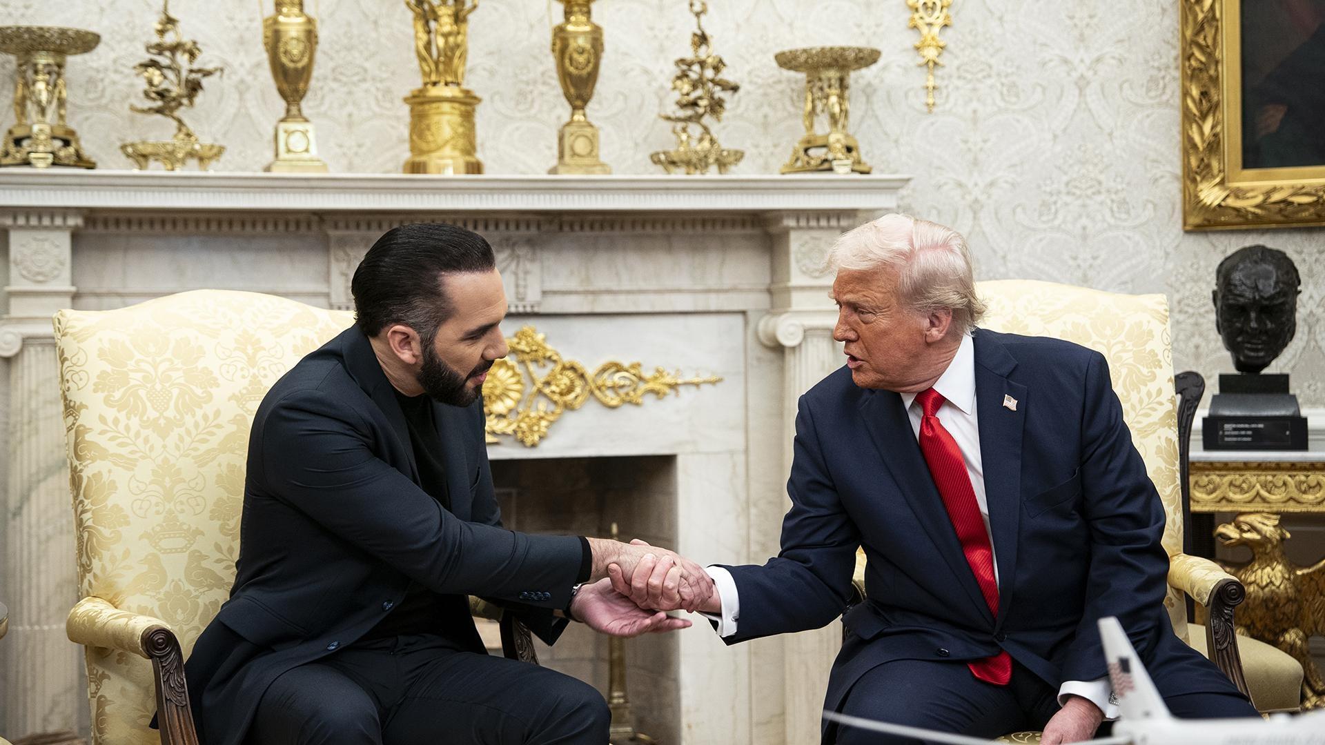 The Salvadoran President Nayib Bukele sitting and shaking hands with President Trump.