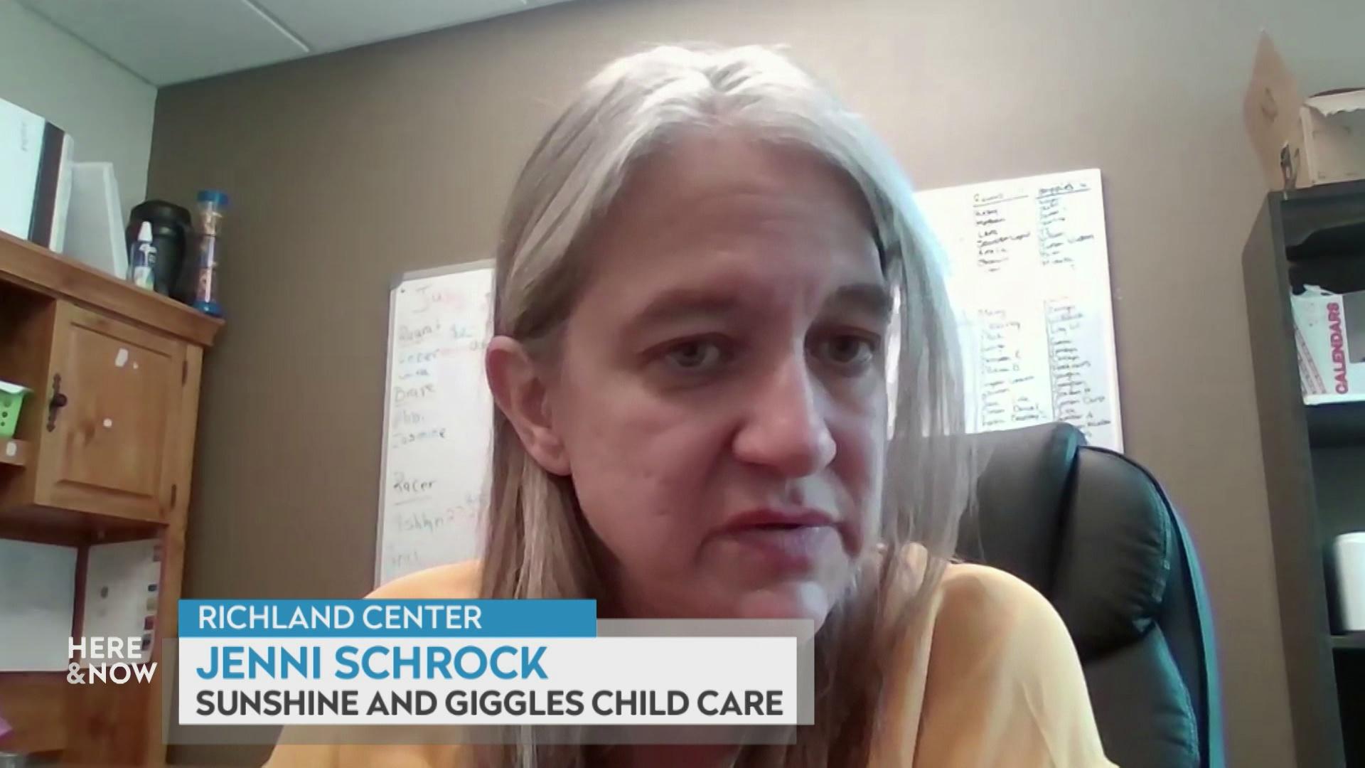 A still image from a video shows Jenni Schrock seated in front of a wooden wall with a whiteboard with a graphic at bottom reading 'Richland Center,' 'Jenni Schrock' and 'Sunshine and Giggles Child Care.'