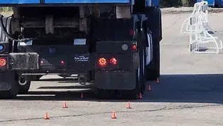 Driver Maneuvers Around Cones at the Garbage Truck Road-eo