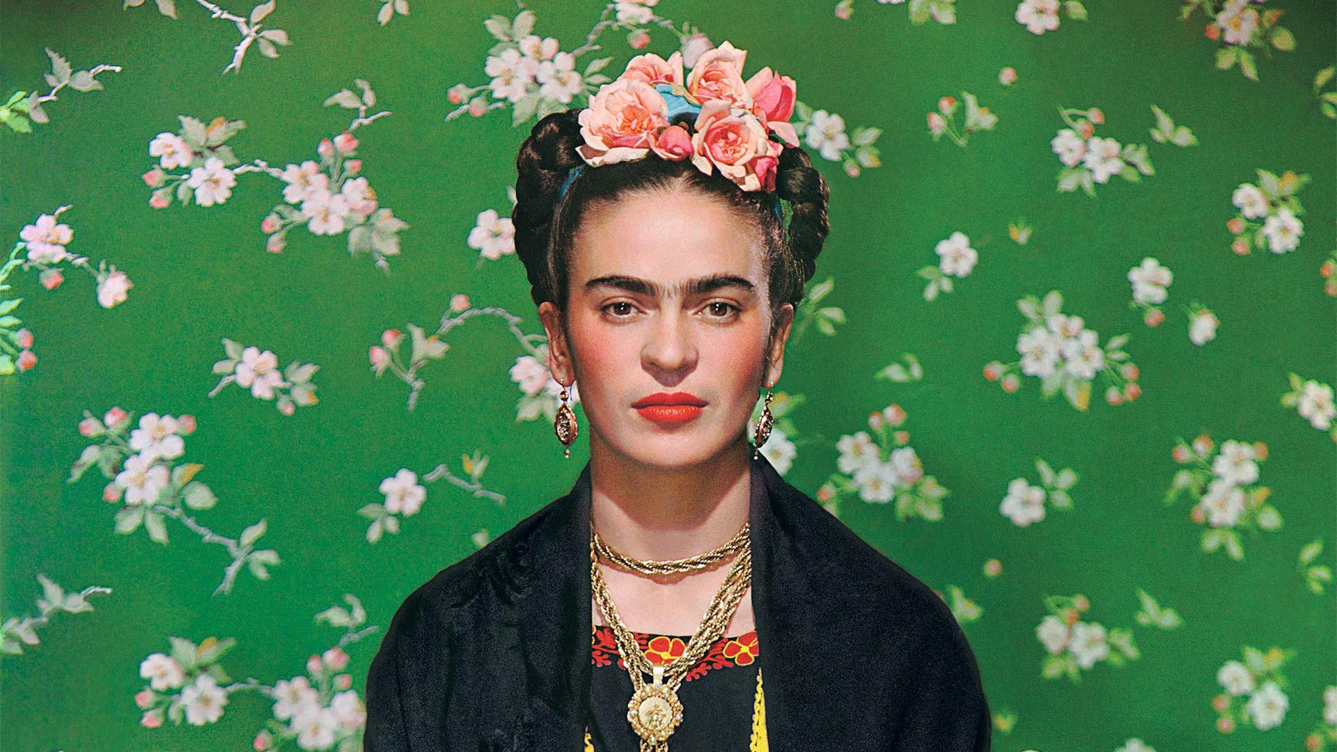 Frida Kahlo with roses in her hair, green floral patter in background