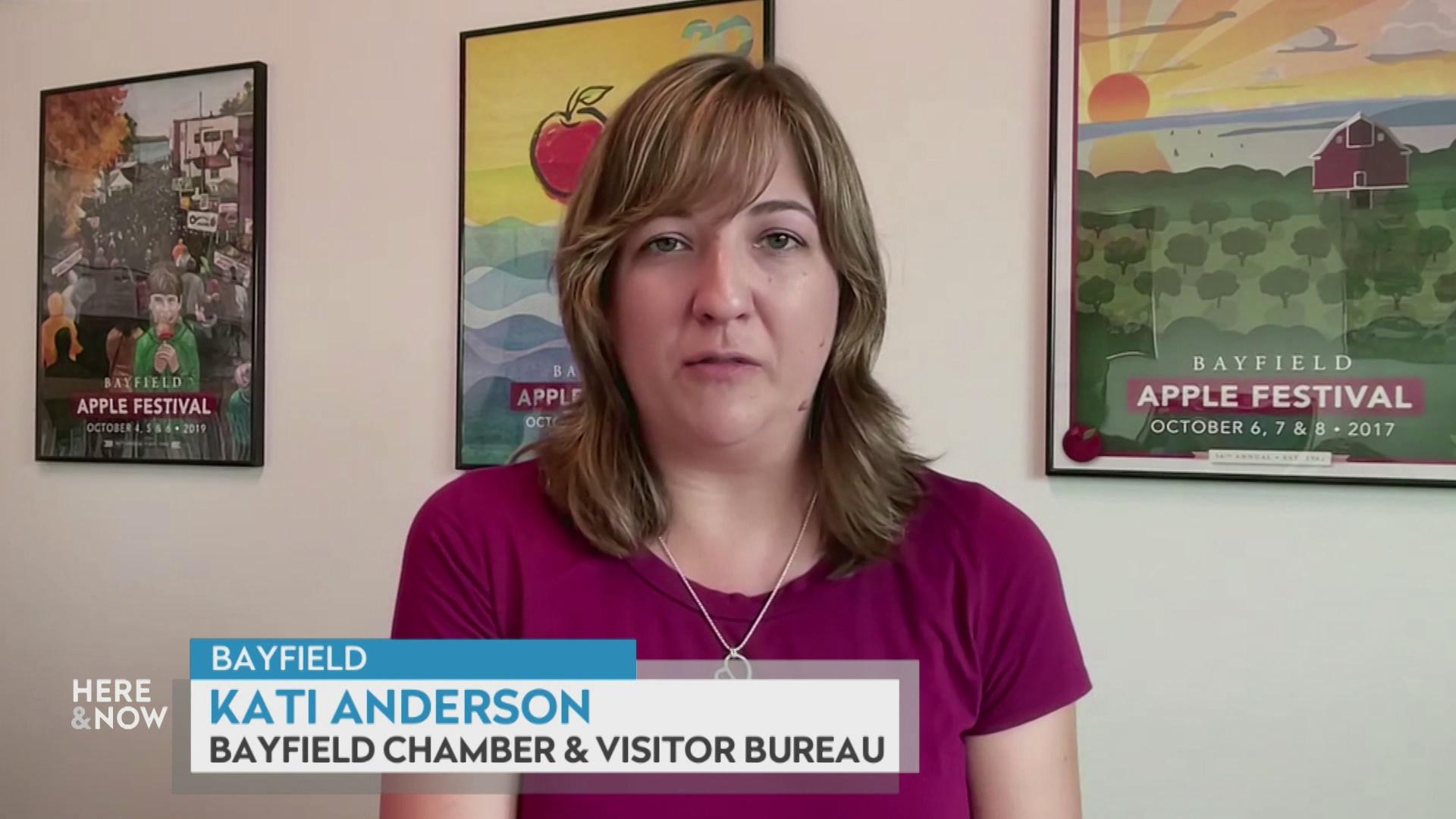 A still image from a video shows Kati Anderson seated in front of three framed posters, each reading 'Bayfield Apple Festival' with a graphic at bottom reading 'Bayfield,' 'Kati Anderson' and 'Bayfield Chamber & Visitor Bureau.'