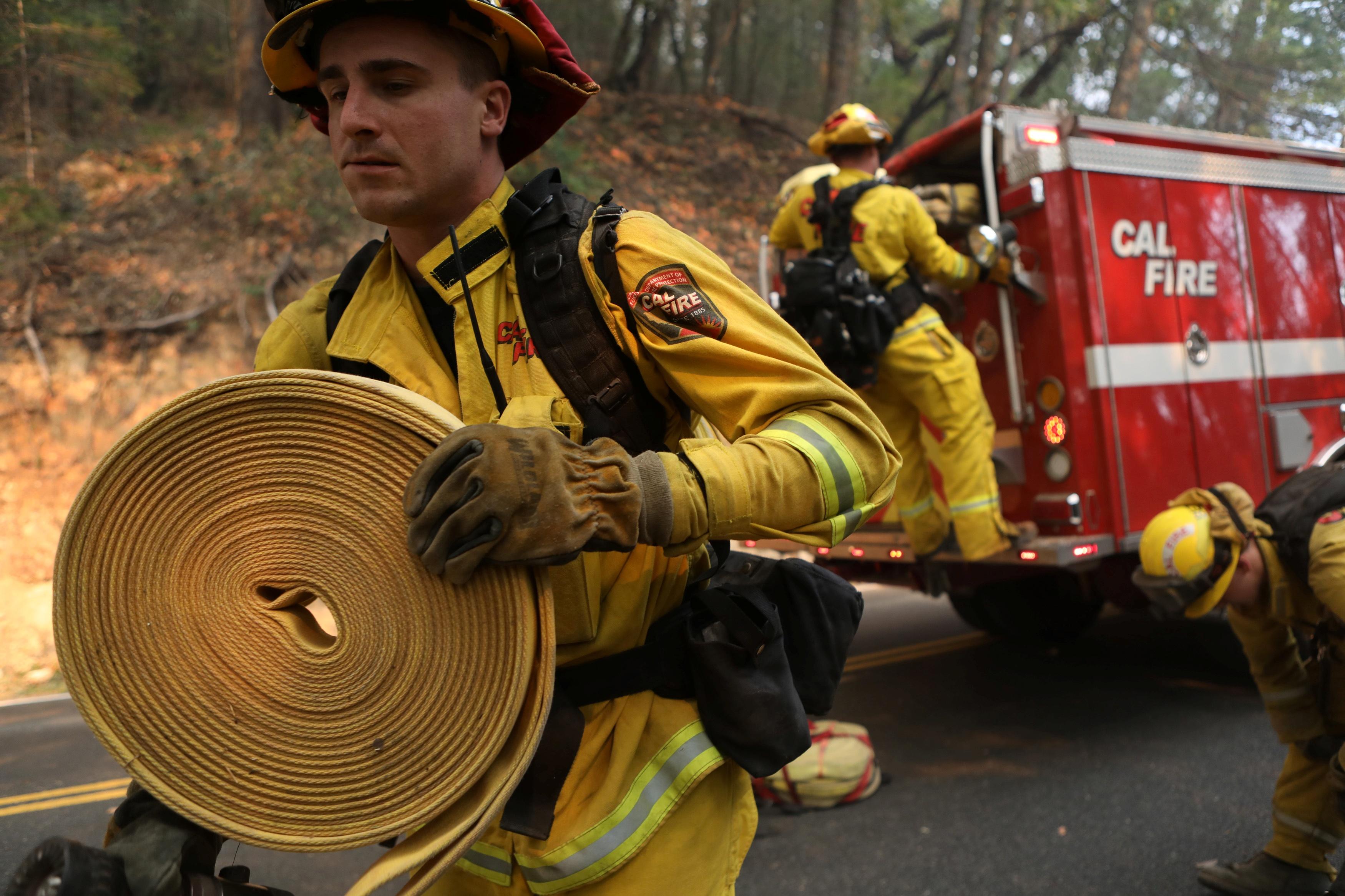 California wildfire death toll rises as teams search ruins