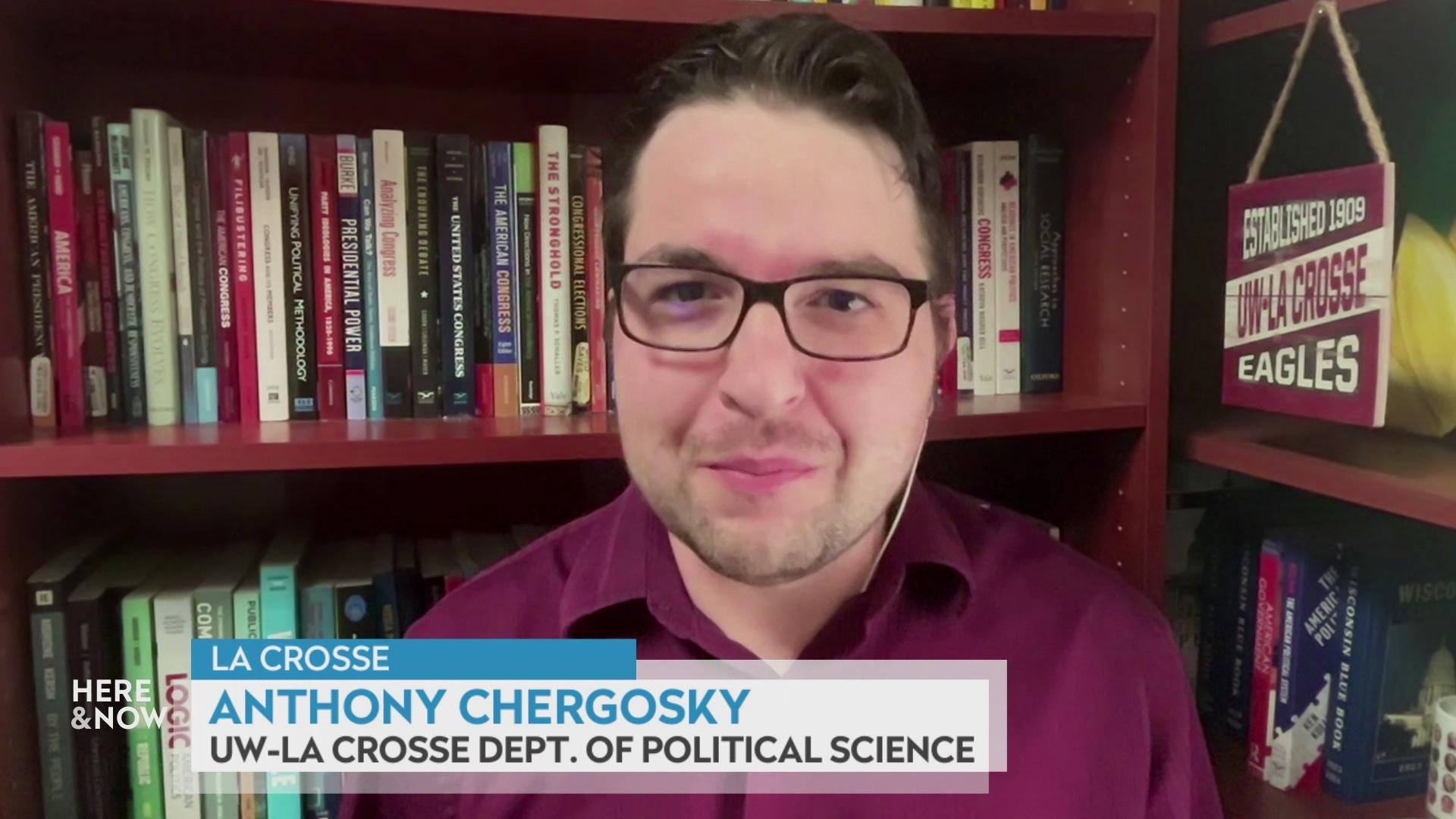 A still image from a video shows Anthony Chergosky seated in front of wooden bookshelves lined with books with a graphic at bottom reading 'La Crosse,' 'Anthony Chergosky' and 'UW-La Crosse Dept. of Political Science.'