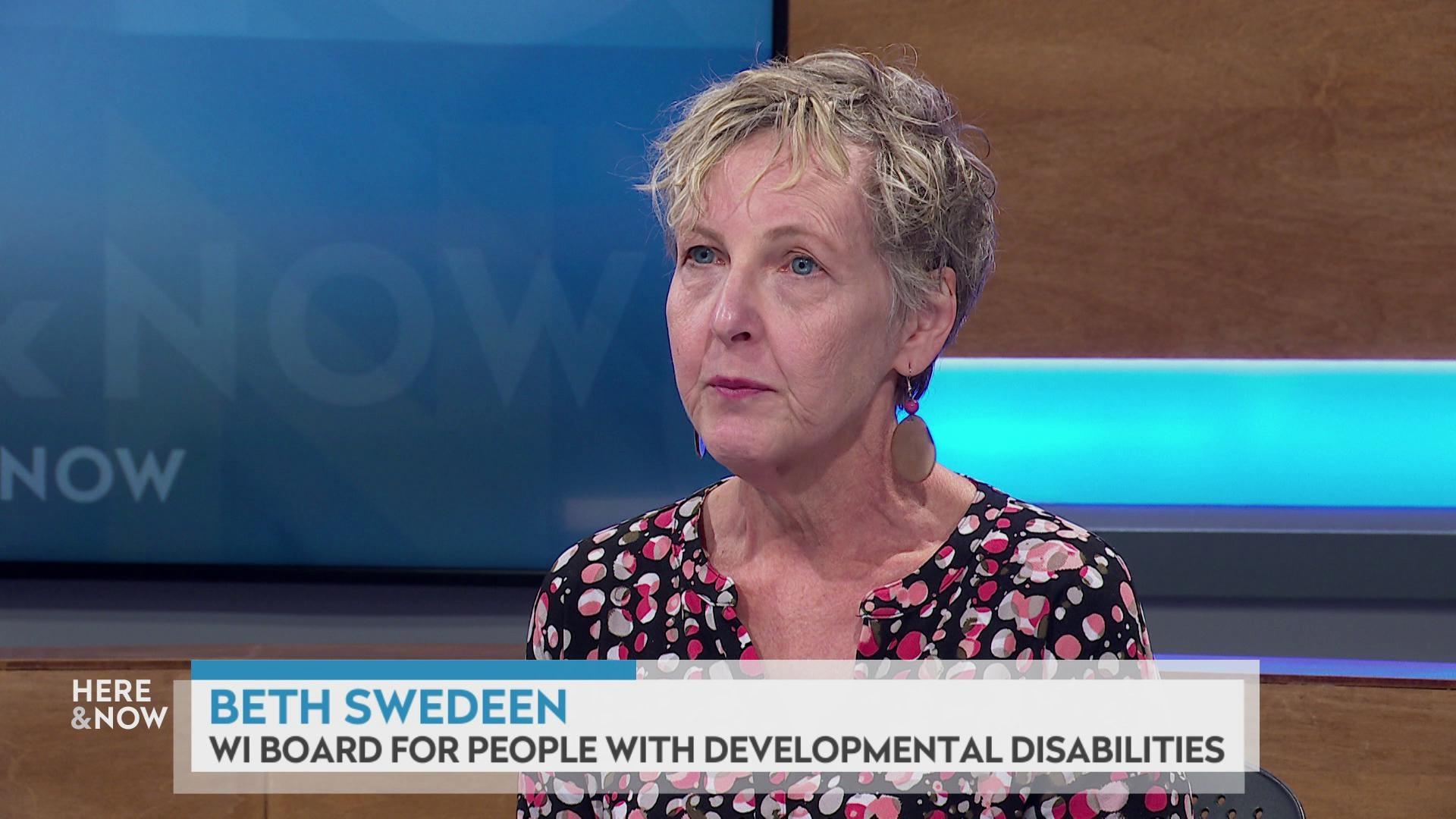 A still image shows Beth Swedeen seated at the 'Here & Now' set featuring wood paneling, with a graphic at bottom reading 'Beth Swedeen' and 'WI Board for People with Developmental Disabilities.'