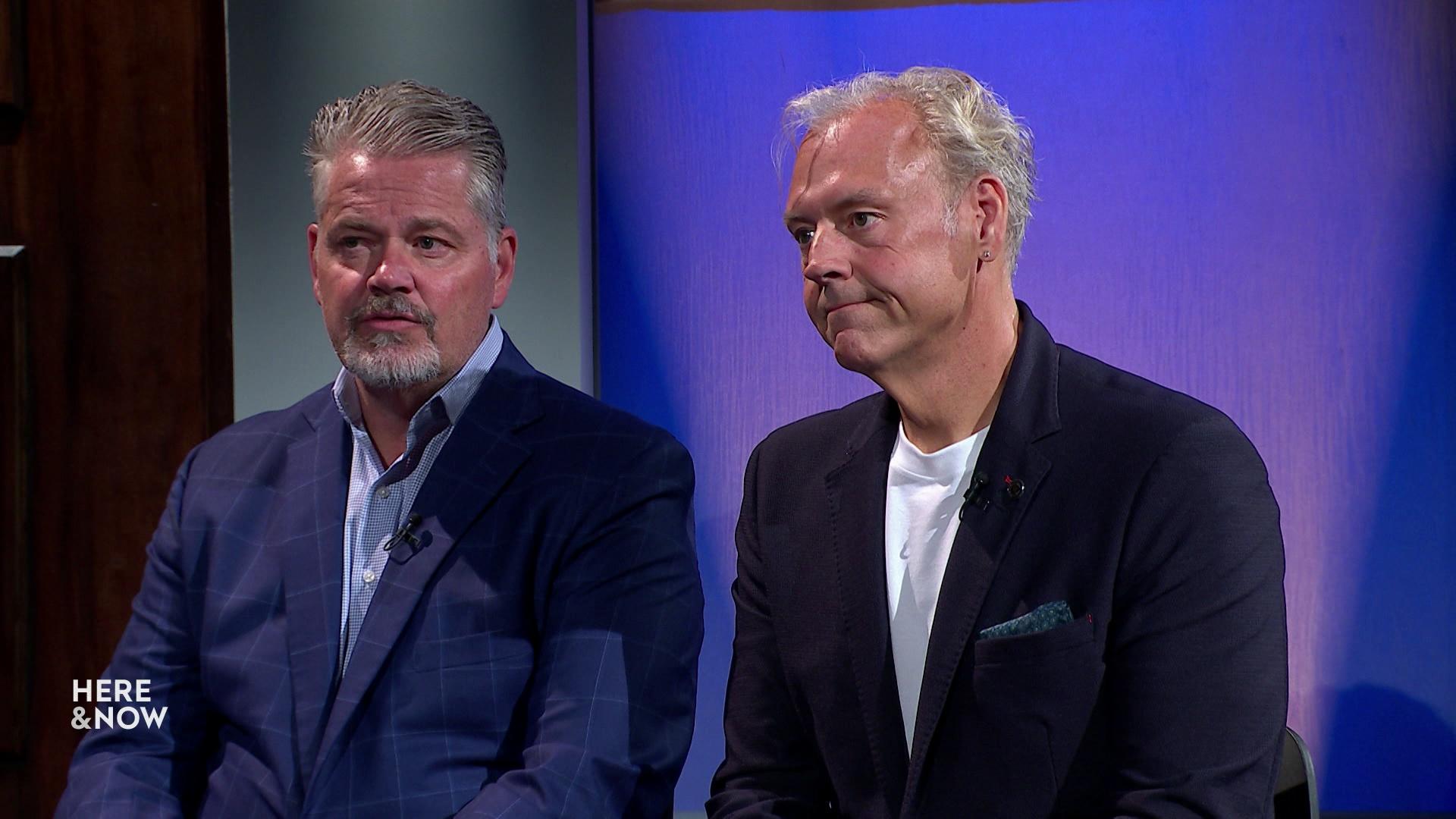 A still image shows Bill McCoshen and Scot Ross seated in front of a blue gradient background.