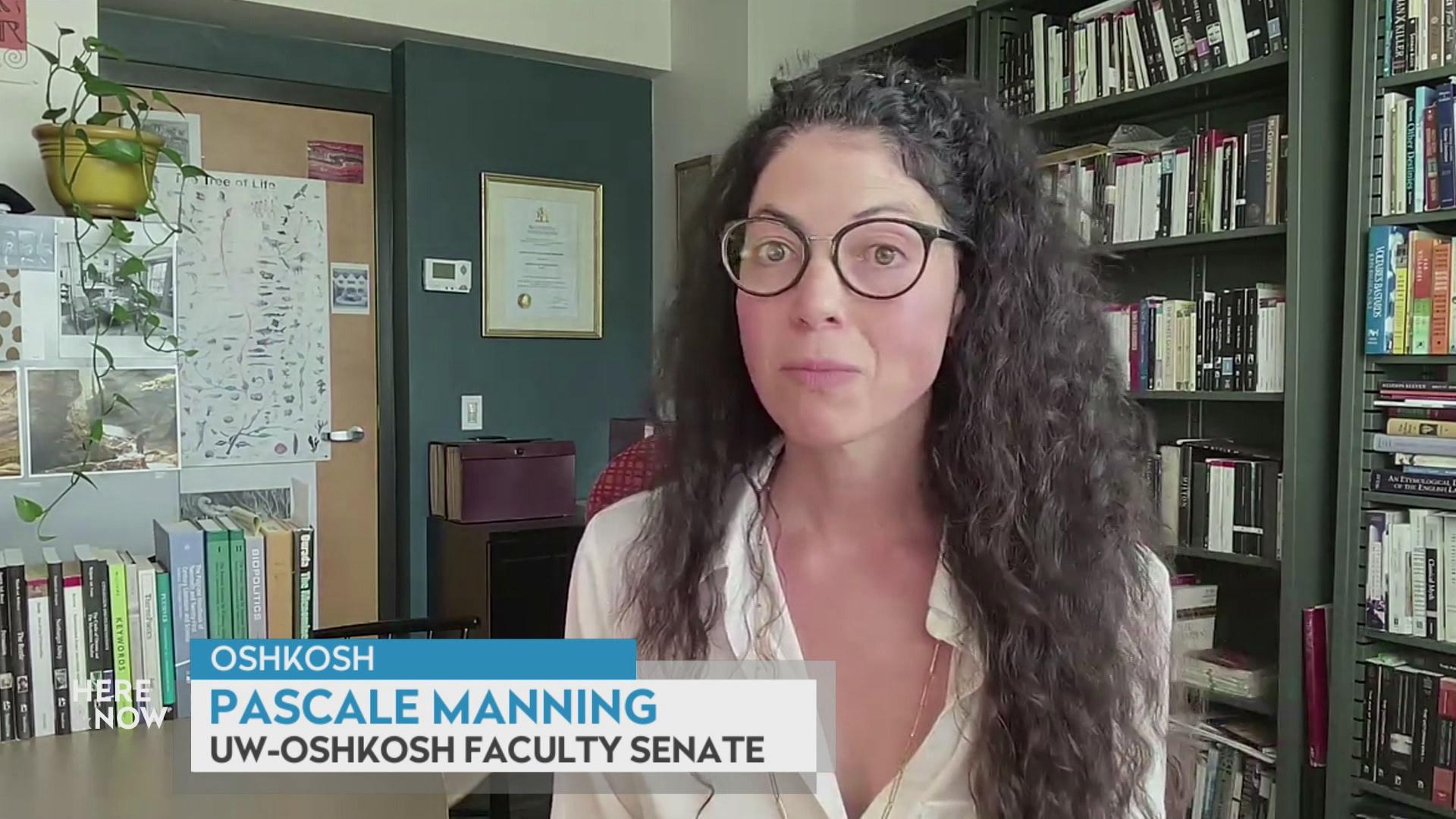 A still image from a video shows Pascale Manning seated in front of a wooden bookshelf filled with books and a green wall with maps and artwork with a graphic at bottom reading 'Oshkosh,' 'Pascale Manning' and 'UW-Oshkosh Faculty Senate.'