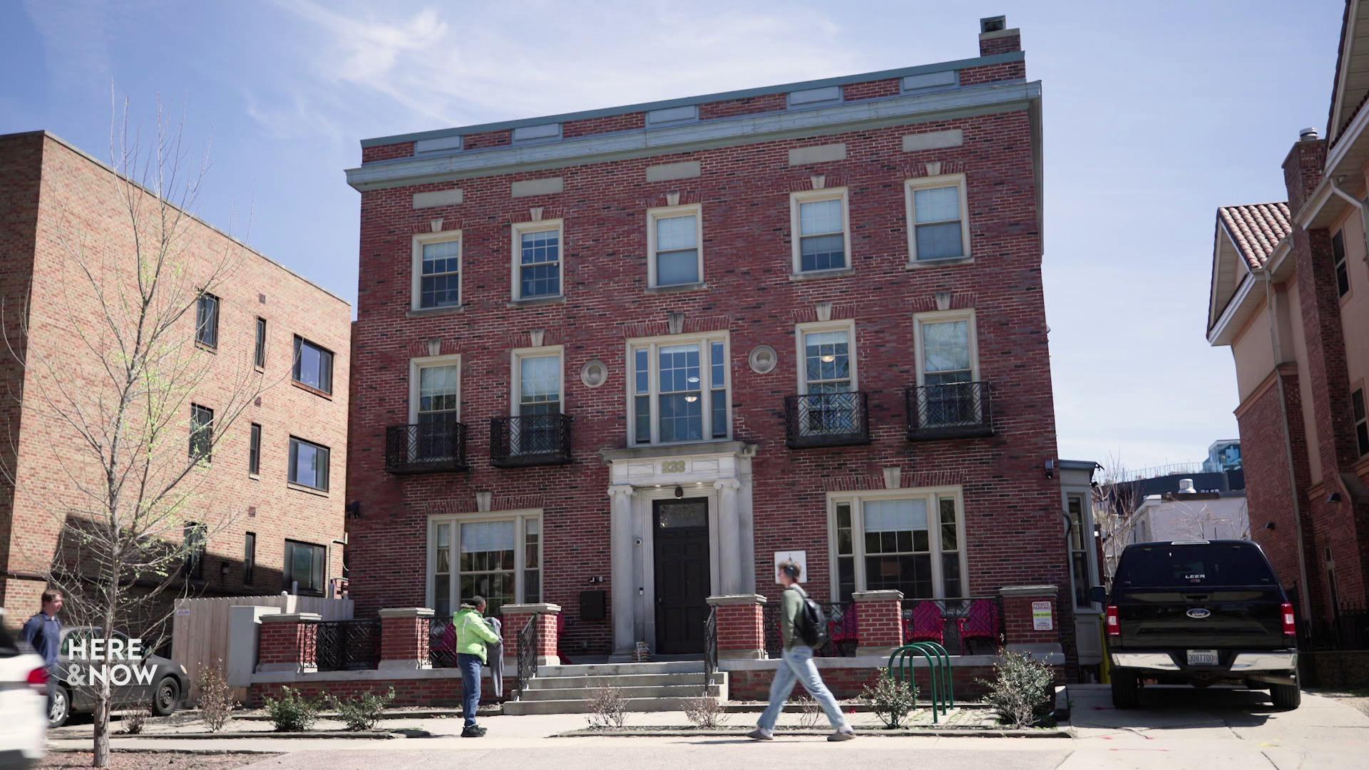 A still image shows Mansfield Hall from the outside, a three-story red brick building.