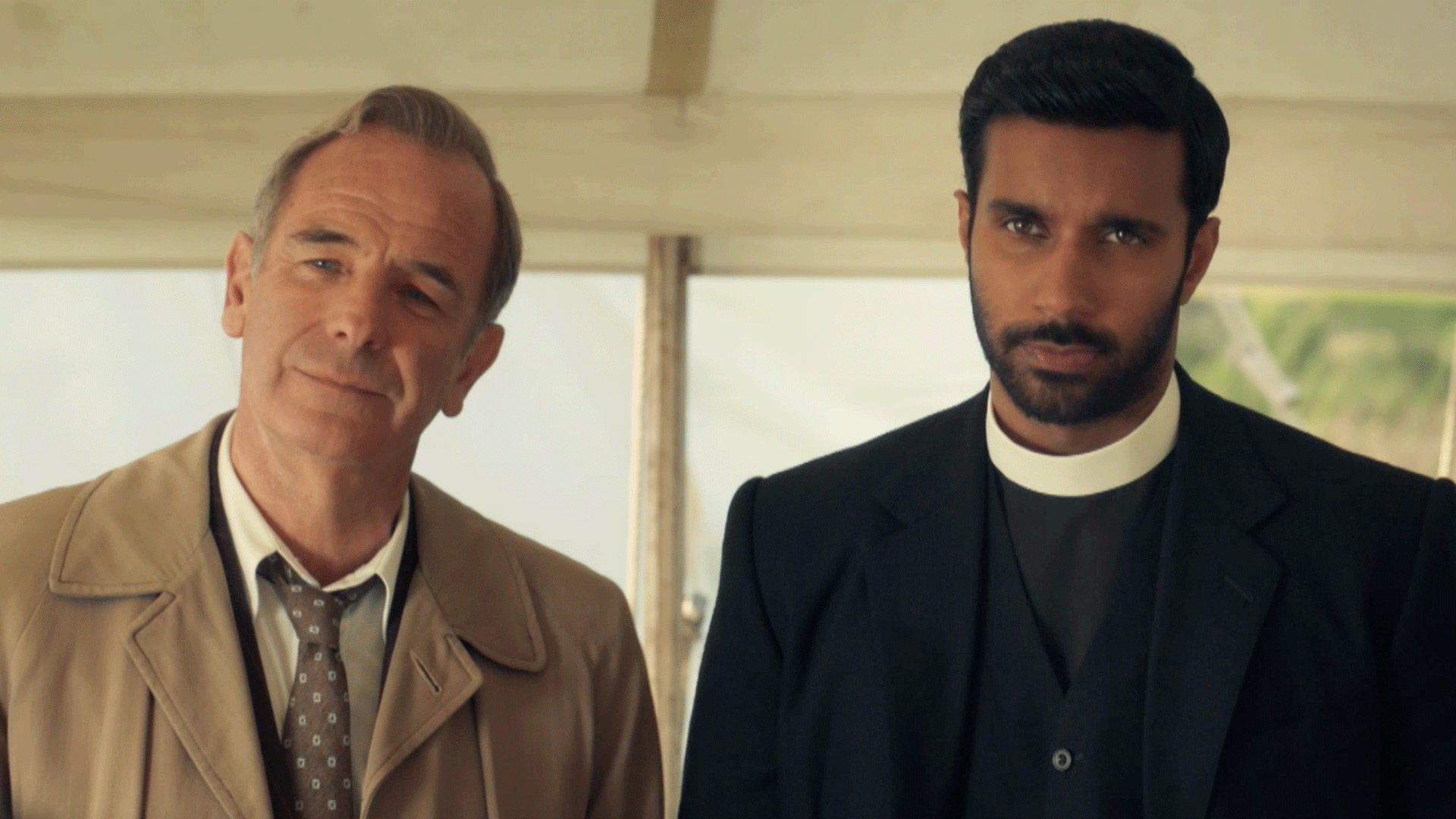 the main two characters of Grantchester looking serious at something just of frame behind the camera perspective
