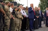 News Wrap: Pentagon says troops will carry firearms in D.C.