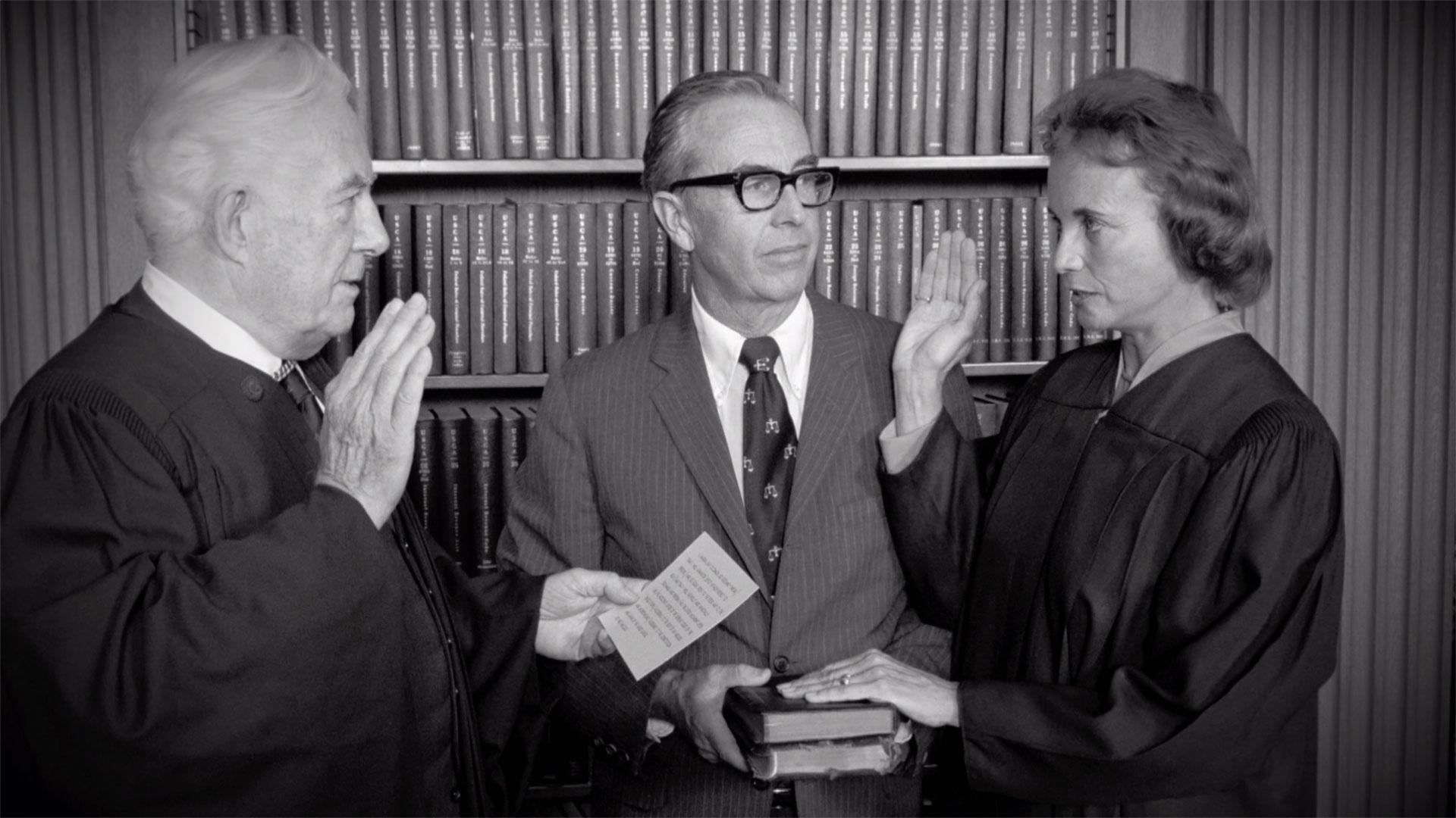Sandra Day O'Connor getting sworn into the Supreme Court in black and white.
