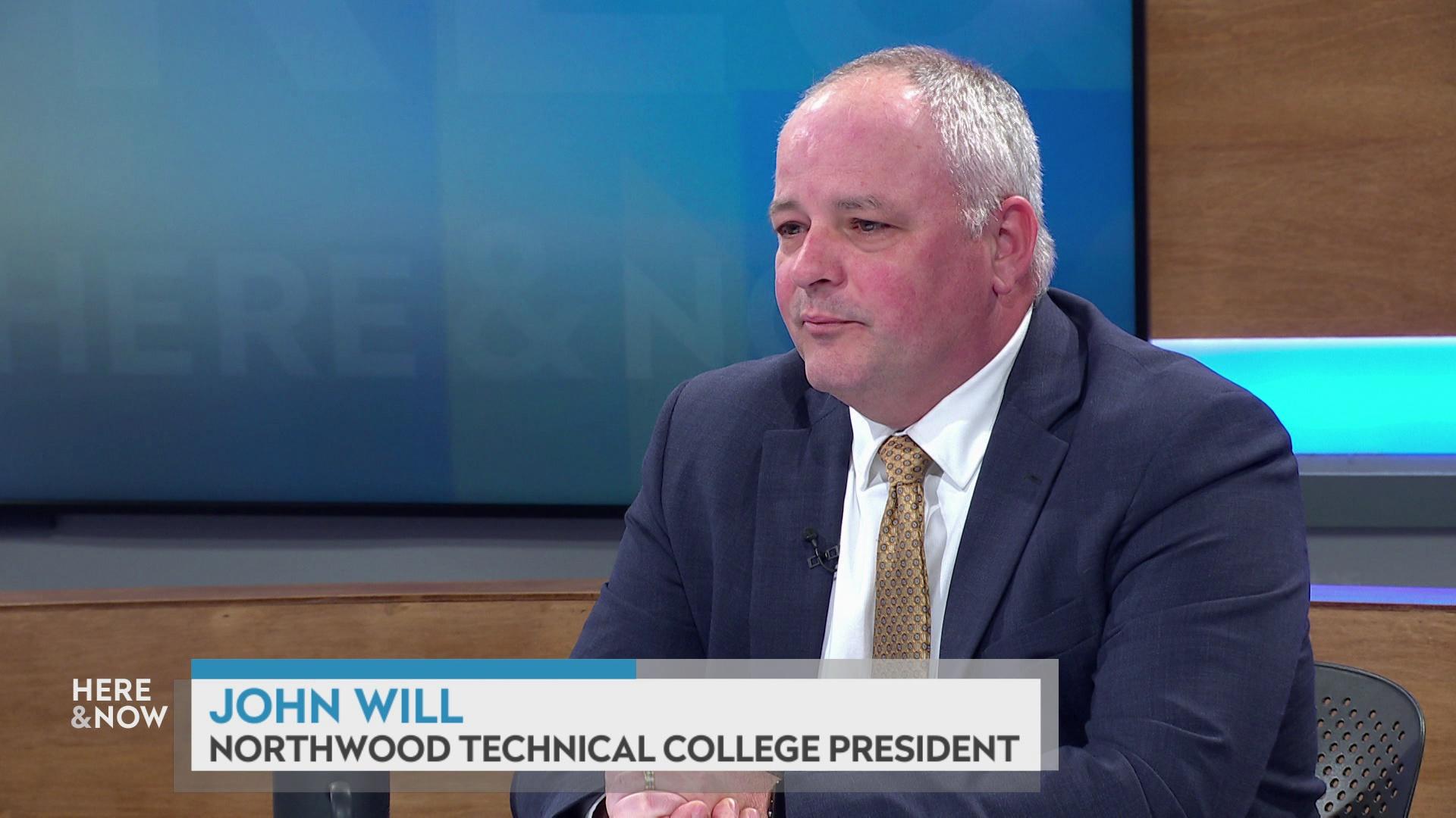 A still image shows John Will seated at the 'Here & Now' set featuring wood paneling, with a graphic at bottom reading 'John Will' and 'Northwood Technical College President.'