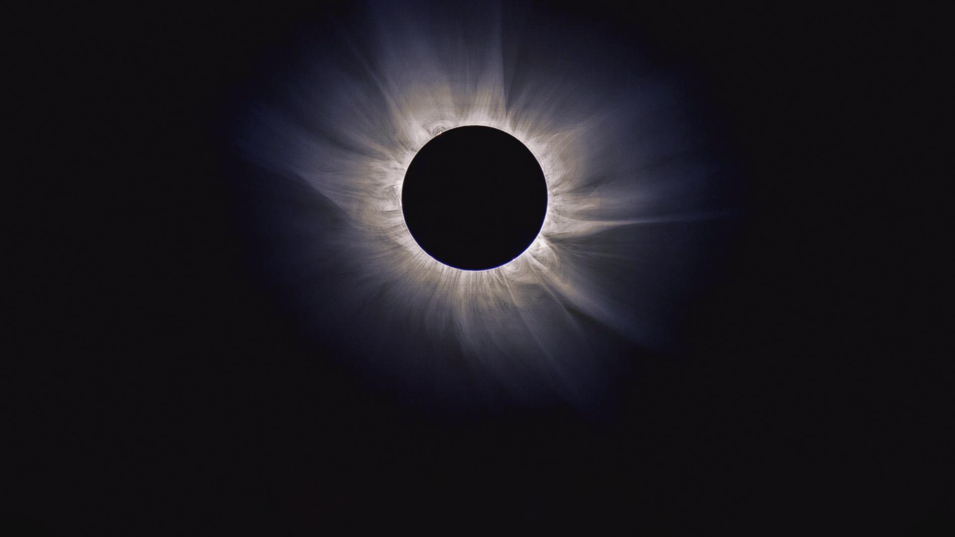 an image of an eclipse where the moon is fully in front of the sun