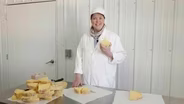 Inga Slices a Truckle of Wisconsin Cheese