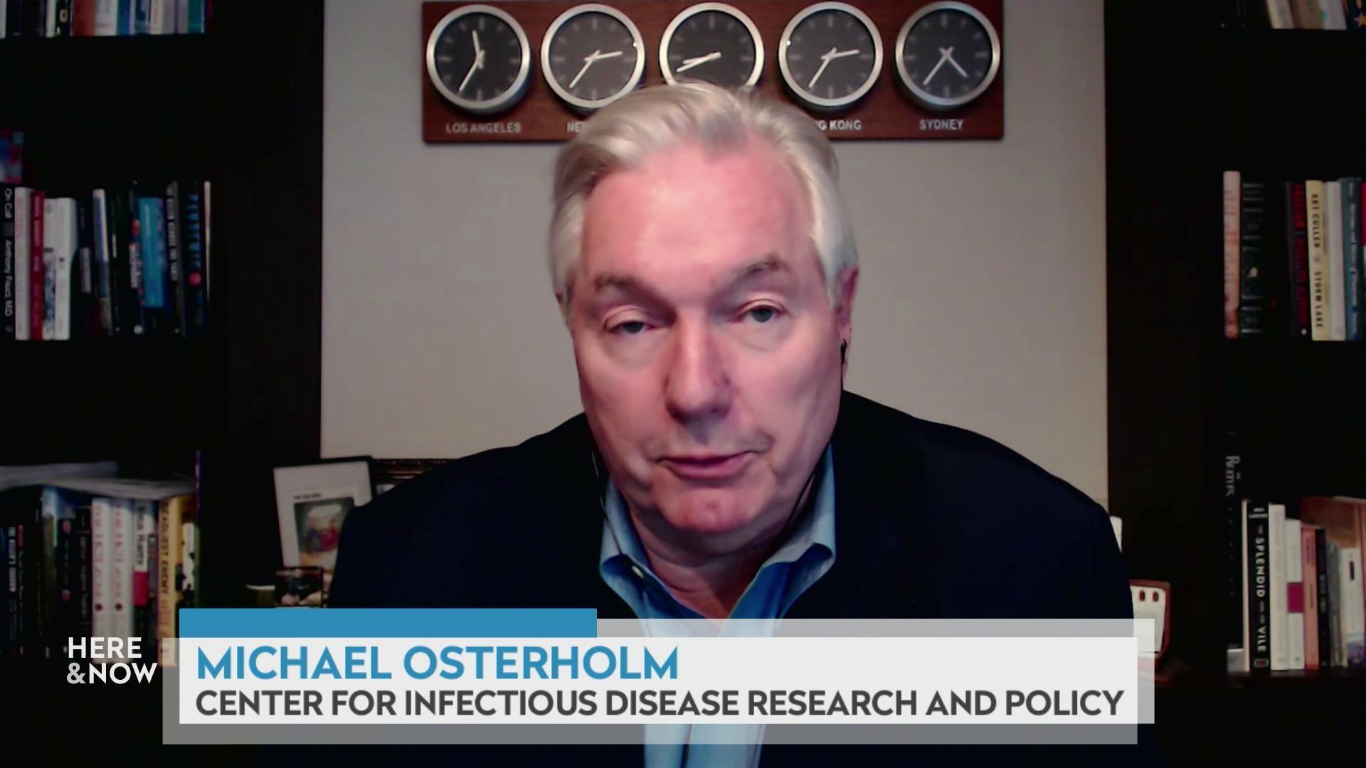 A still image shows Michael Osterholm seated in front of five clocks showing different zones and two bookshelves, with a graphic at the bottom that reads 'Michael Osterholm' and 'Center for Infectious Disease Research and Policy.'