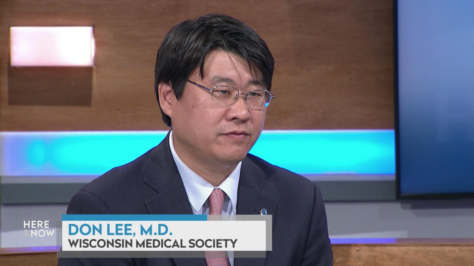 A still image shows Don Lee seated at the 'Here & Now' set featuring wood paneling, with a graphic at bottom reading 'Don Lee' and 'Wisconsin Medical Society.'