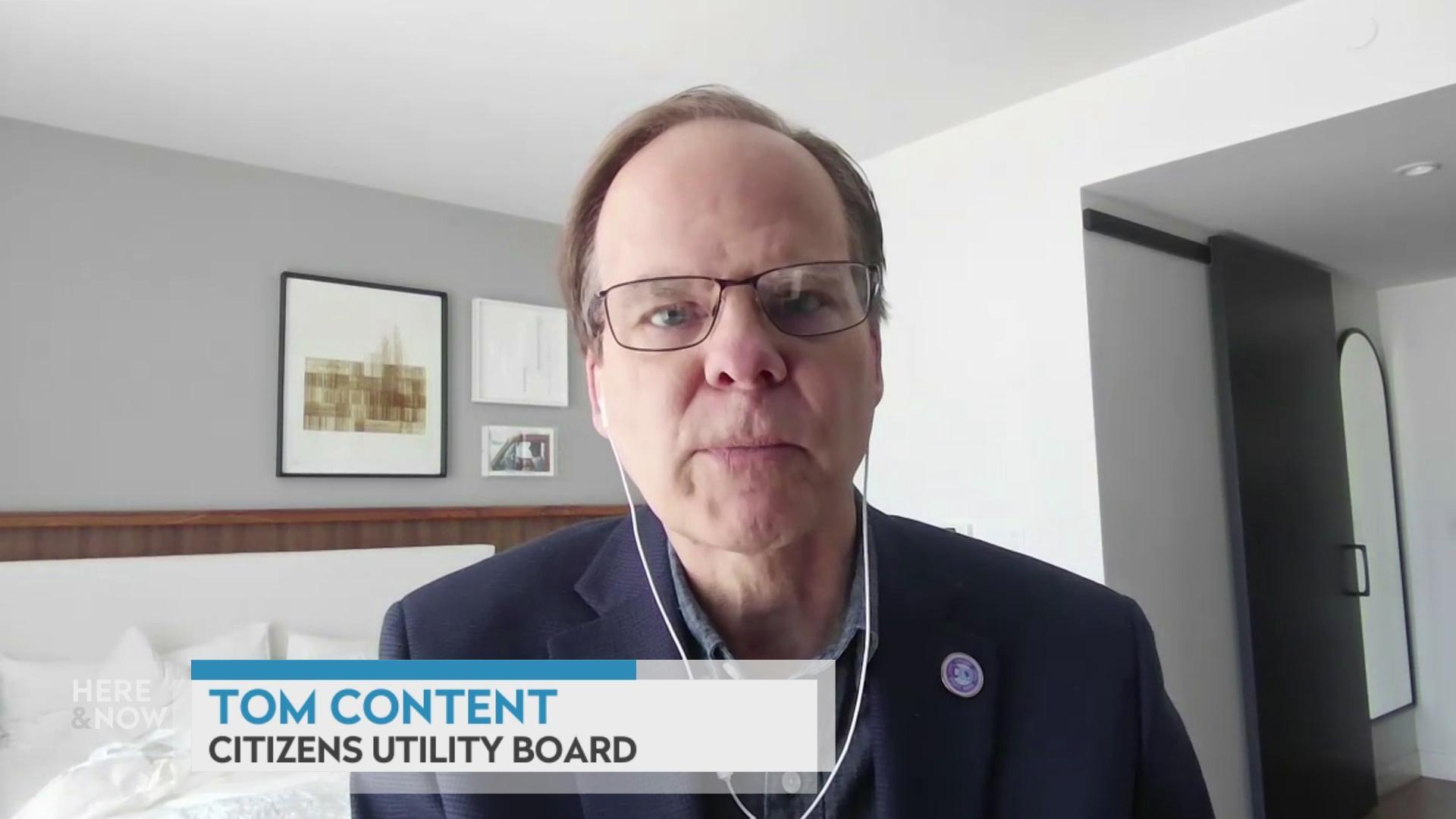 A still image shows Tom Content seated in a hotel room, with a graphic at the bottom that reads 'Tom Content' and 'Citizens Utility Board.'