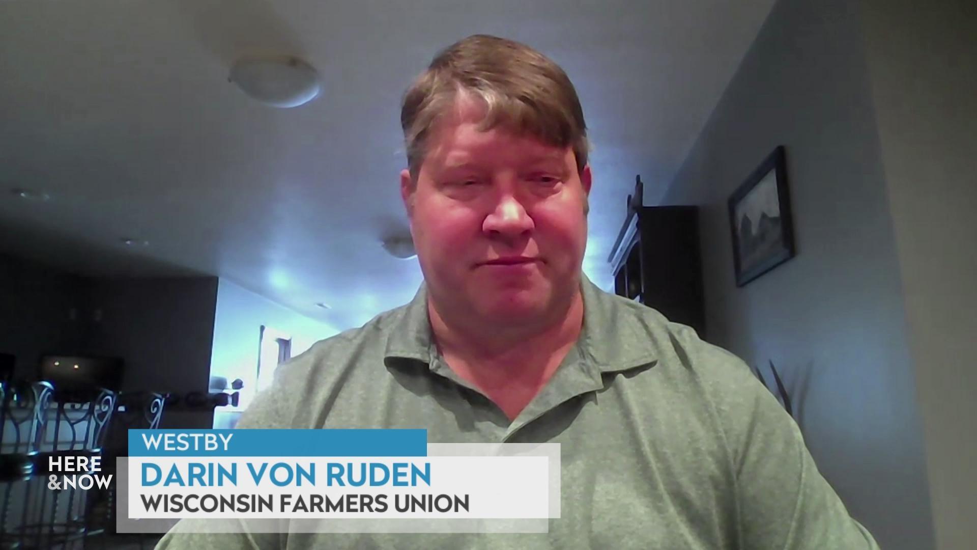 A still image from a video shows Darin Von Ruden seated in front of walls with framed artwork and chair with a graphic at bottom reading 'Westby,' 'Darin Von Ruden' and 'Wisconsin Farmers Union.'