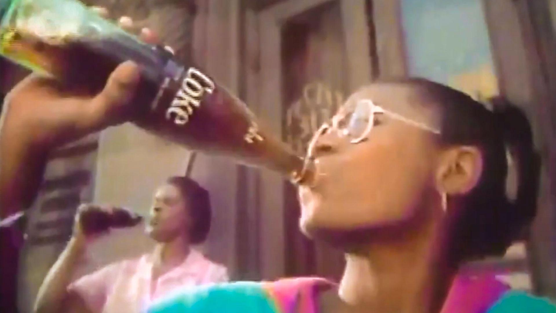 Teen girl drinking Coke from glass bottle in vintage ad