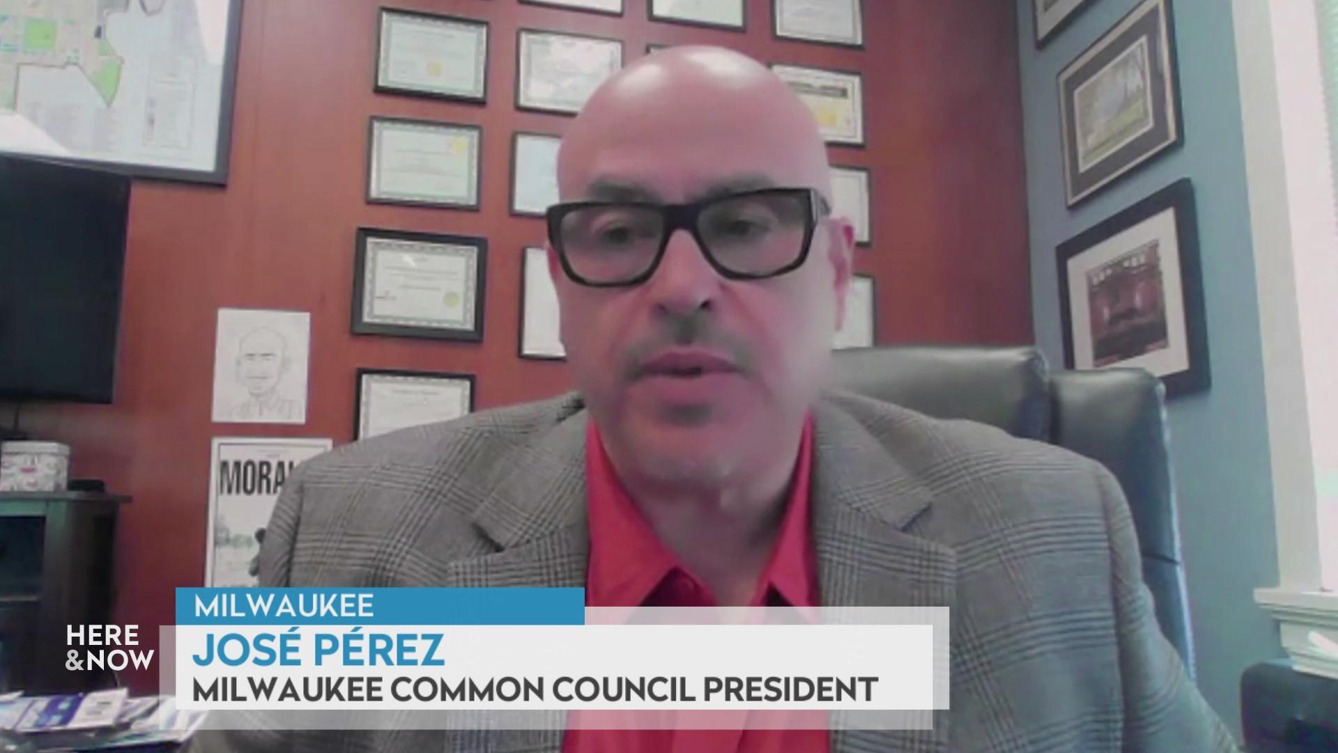 A still image shows José Pérez seated in front of a wood paneled wall with lots of degrees and certificates with a graphic at the bottom reading 'Milwaukee,' 'José Pérez' and 'Milwaukee Common Council President.'