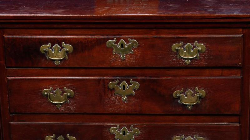 A Queen Anne figured walnut cross-banded chest on stand