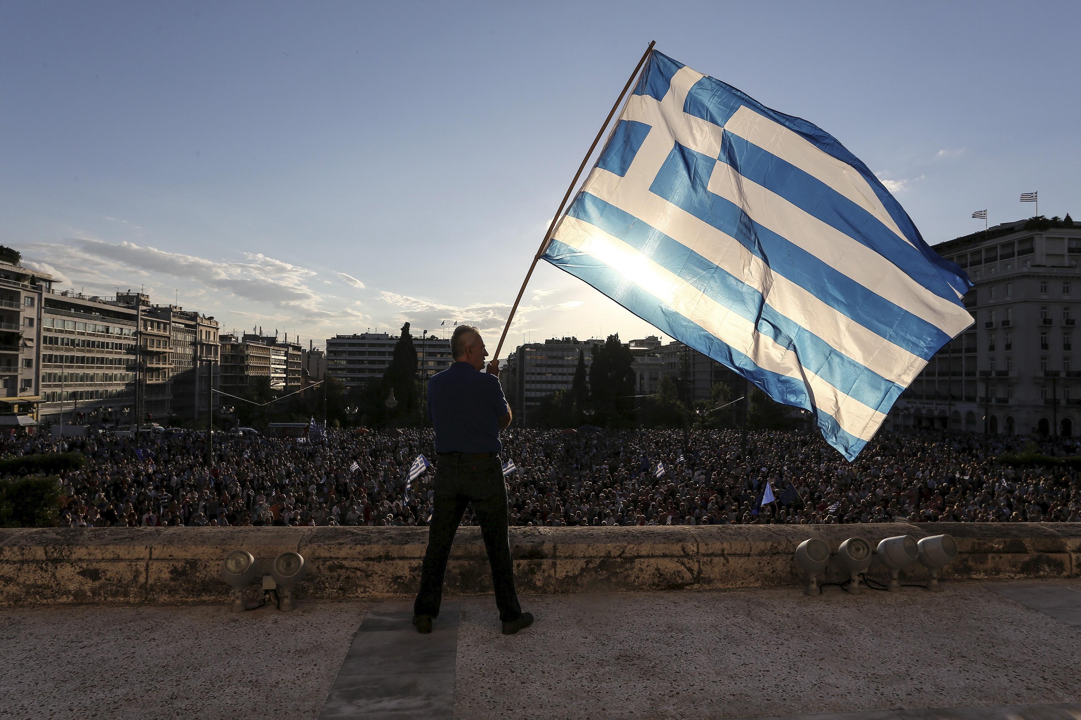 Awaiting debt deal, Greeks resist expected reforms