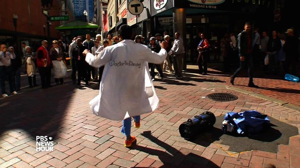 Donning his white coat, this doctor dances for dollars image