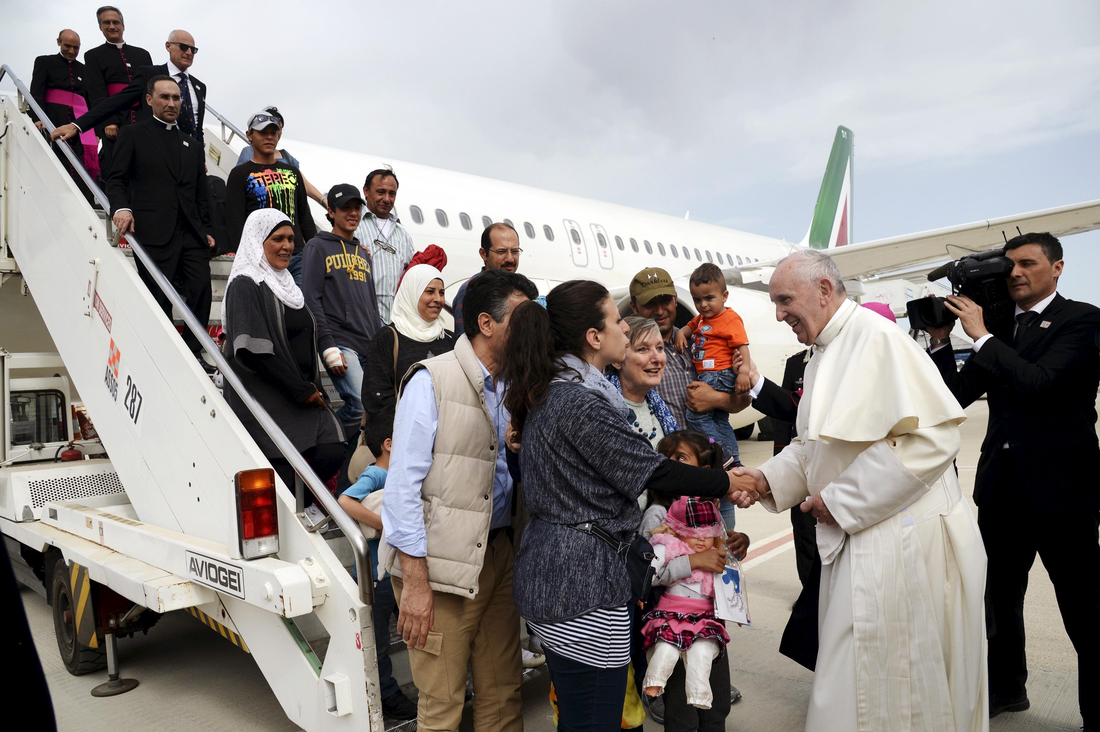 Refugees’ journey ends with a ride on the pope’s plane