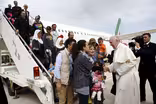 Refugees’ journey ends with a ride on the pope’s plane