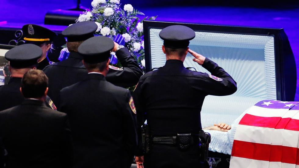 News Wrap: Funerals for slain Dallas police officers begin image