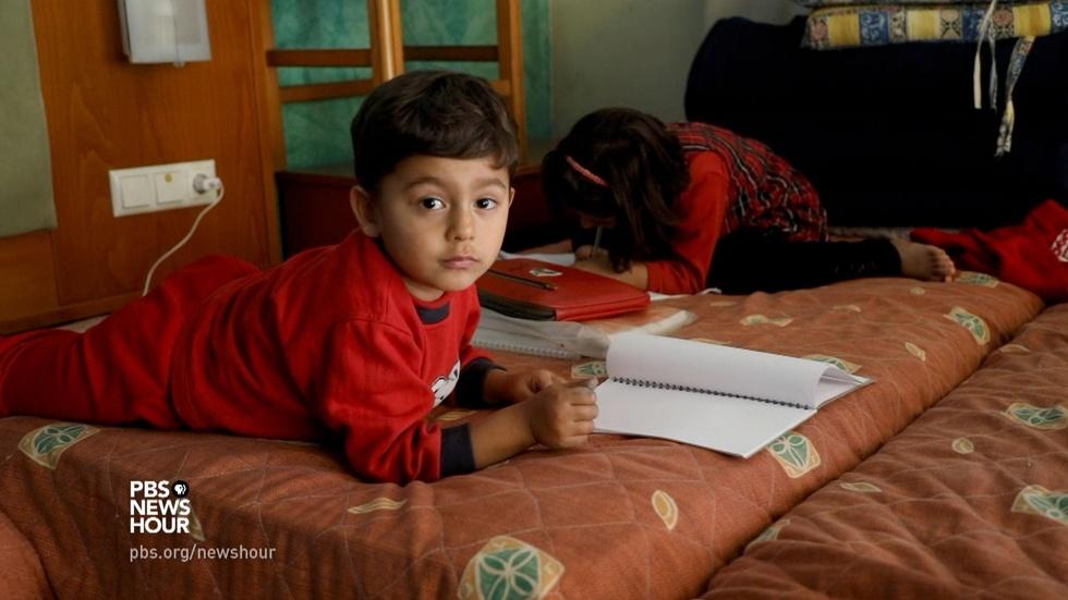 Greek village welcomes migrants, while others turn them away image