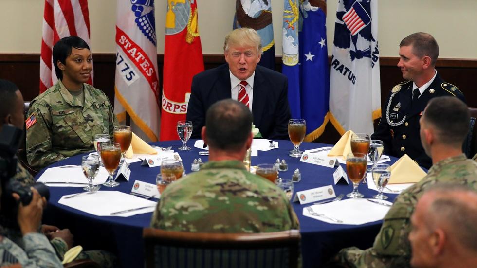 News Wrap: Trump visits CENTCOM, defends travel ban image