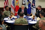 News Wrap: Trump visits CENTCOM, defends travel ban