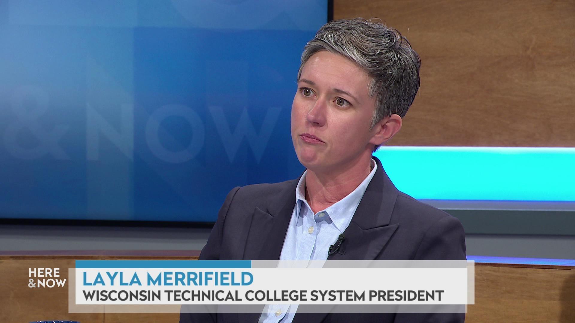 A still image shows Layla Merrifield seated at the 'Here & Now' set featuring wood paneling, with a graphic at bottom reading 'Layla Merrifield' and 'Wisconsin Technical College System president.'