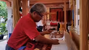 Isaac Vásquez and Jeronimo Vásquez on their family's weaving