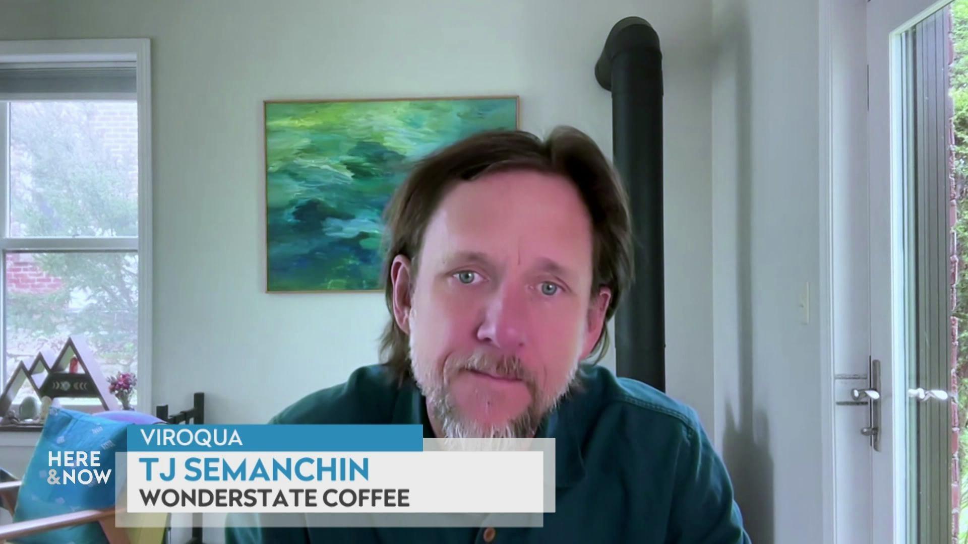 A still image shows TJ Semanchin seated in front of a green and blue painting, with a caption at the bottom that reads 'Viroqua,' 'TJ Semanchin' and 'Wonderstate Coffee.'
