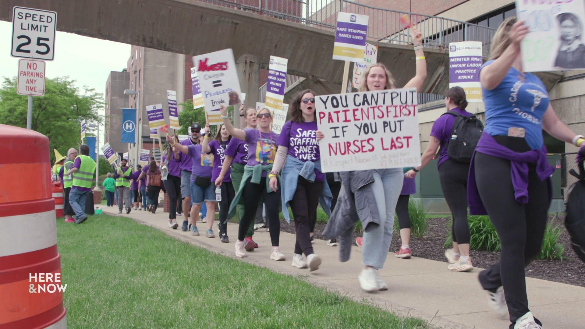 A still image shows a large group of nurses picketing in a line, wearing purple and holding signs that read 'you can't put patients first if you put nurses last.'