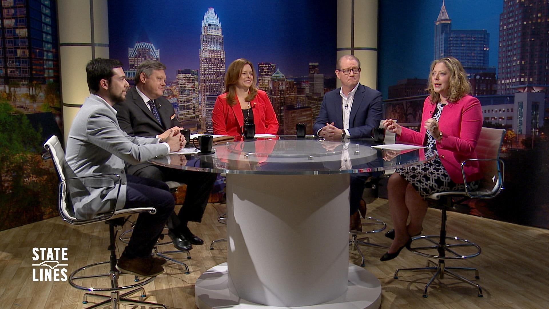 Guest host Donna King and panelists sit around a round table with images of the Raleigh skyline on the set behind them.