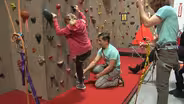 Children with disabilities learn skills by rock climbing