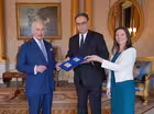 King Charles presented with banknotes bearing his portrait