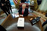 News Wrap: Trump signs GOP tax bill into law